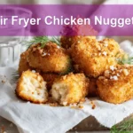 Air Fryer Chicken Nuggets on white napkin with pickles and glass of water