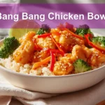 Bang Bang Chicken Bowl with tender-cooked chicken pieces rice cauliflower rice vegetables zesty creamy sauce lime