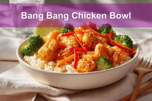 Bang Bang Chicken Bowl with tender-cooked chicken pieces rice cauliflower rice vegetables zesty creamy sauce lime
