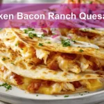 Chicken Bacon Ranch Quesadilla on white napkin with glass of water and sliced view