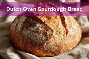 Dutch Oven Sourdough Bread presented on white cloth with clear glass of water beside it