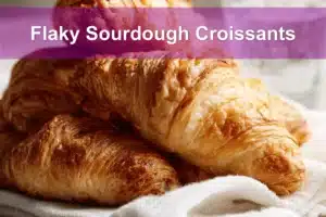 Flaky Sourdough Croissants on white napkin with water, clean and warm setup