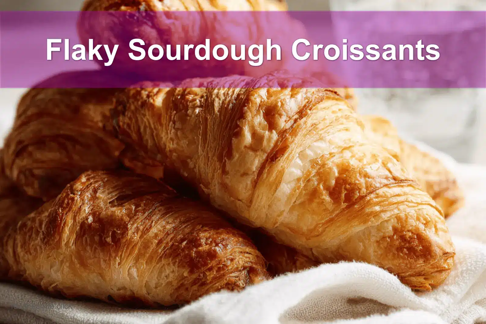 Flaky Sourdough Croissants on white napkin with water, clean and warm setup