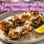 Garlic Parmesan Chicken Skewers Easy Delicious Recipe plated skewers with cheese herbs and lemon