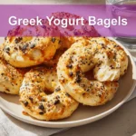 Golden-brown Greek Yogurt Bagels with seasoning, soft interior, and melted ingredients on a bright setup.