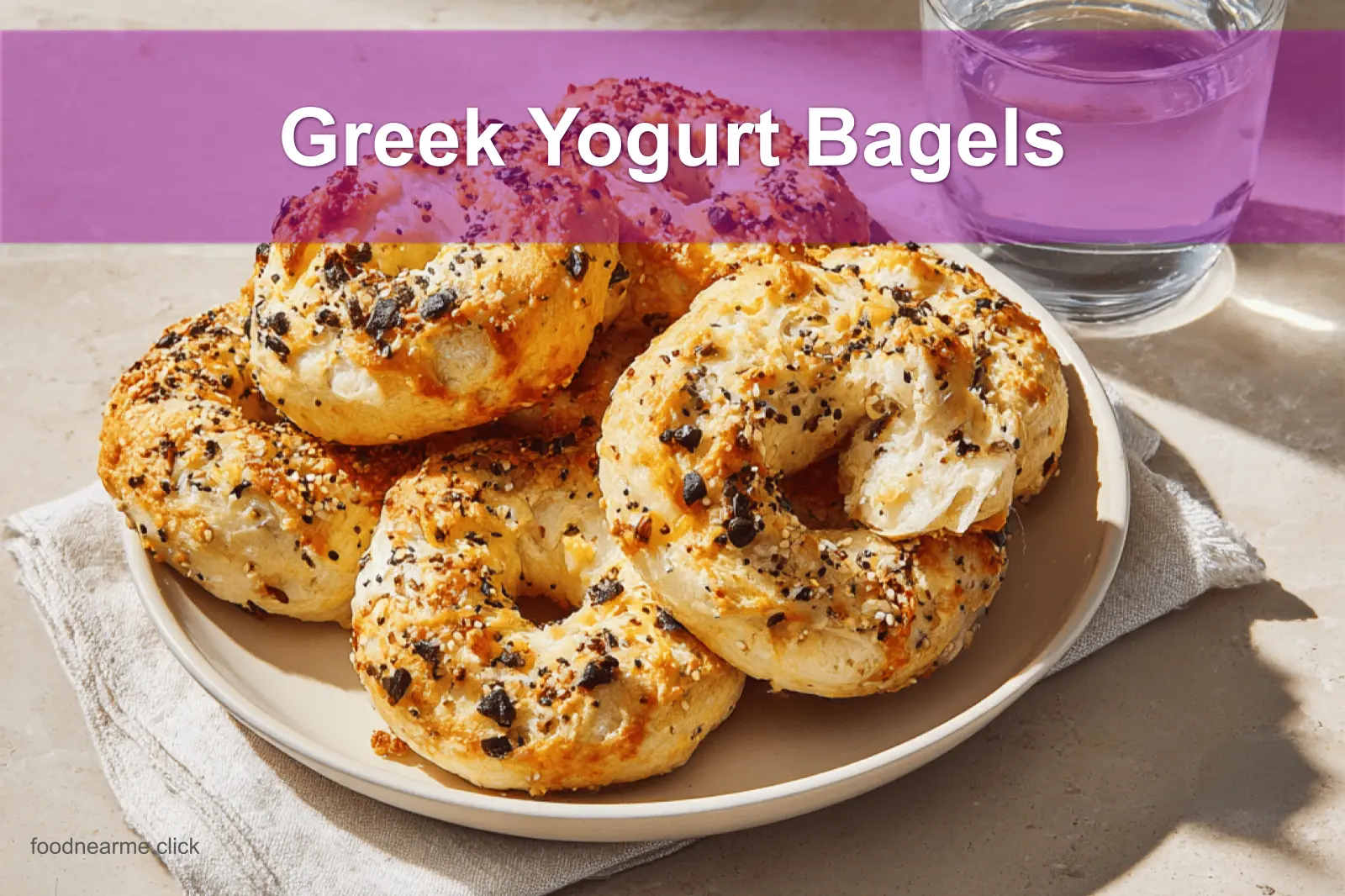 Golden-brown Greek Yogurt Bagels with seasoning, soft interior, and melted ingredients on a bright setup.