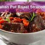Italian Pot Roast Stracotto in rustic bowl on white cloth napkin with glass of water