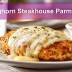 Longhorn Steakhouse Parmesan Chicken on a white napkin with water near it.