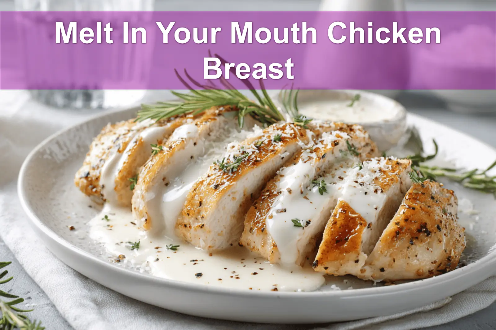 Melt In Your Mouth Chicken Breast plated with creamy white sauce and grated hard cheese warm lighting