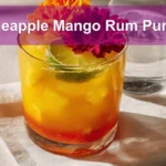 Pineapple Mango Rum Punch in a vibrant tropical setup with garnishes