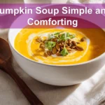 Pumpkin Soup Simple and Comforting creamy bowl on white cloth with glass of water