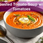 Roasted Tomato Soup with Tomatoes in bowl with grilled cheese basil under warm natural light