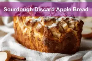 Sourdough Discard Apple Bread with cinnamon, apples, and powdered sugar, warm golden tones.