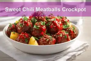 Sweet Chili Meatballs Crockpot in white dish with herbs, pineapple, and a glass of water