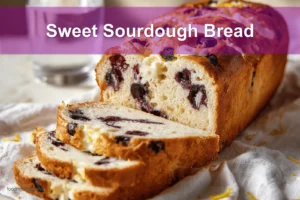 Sweet Sourdough Bread with golden crust, blueberries, and cheese on a white cloth napkin.