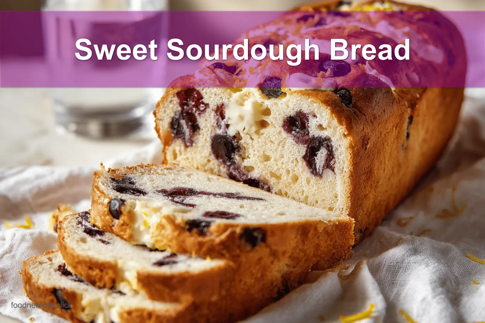 Sweet Sourdough Bread with golden crust, blueberries, and cheese on a white cloth napkin.