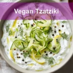 Vegan Tzatziki in ceramic bowl with cucumber dill lemon and olive oil drizzle