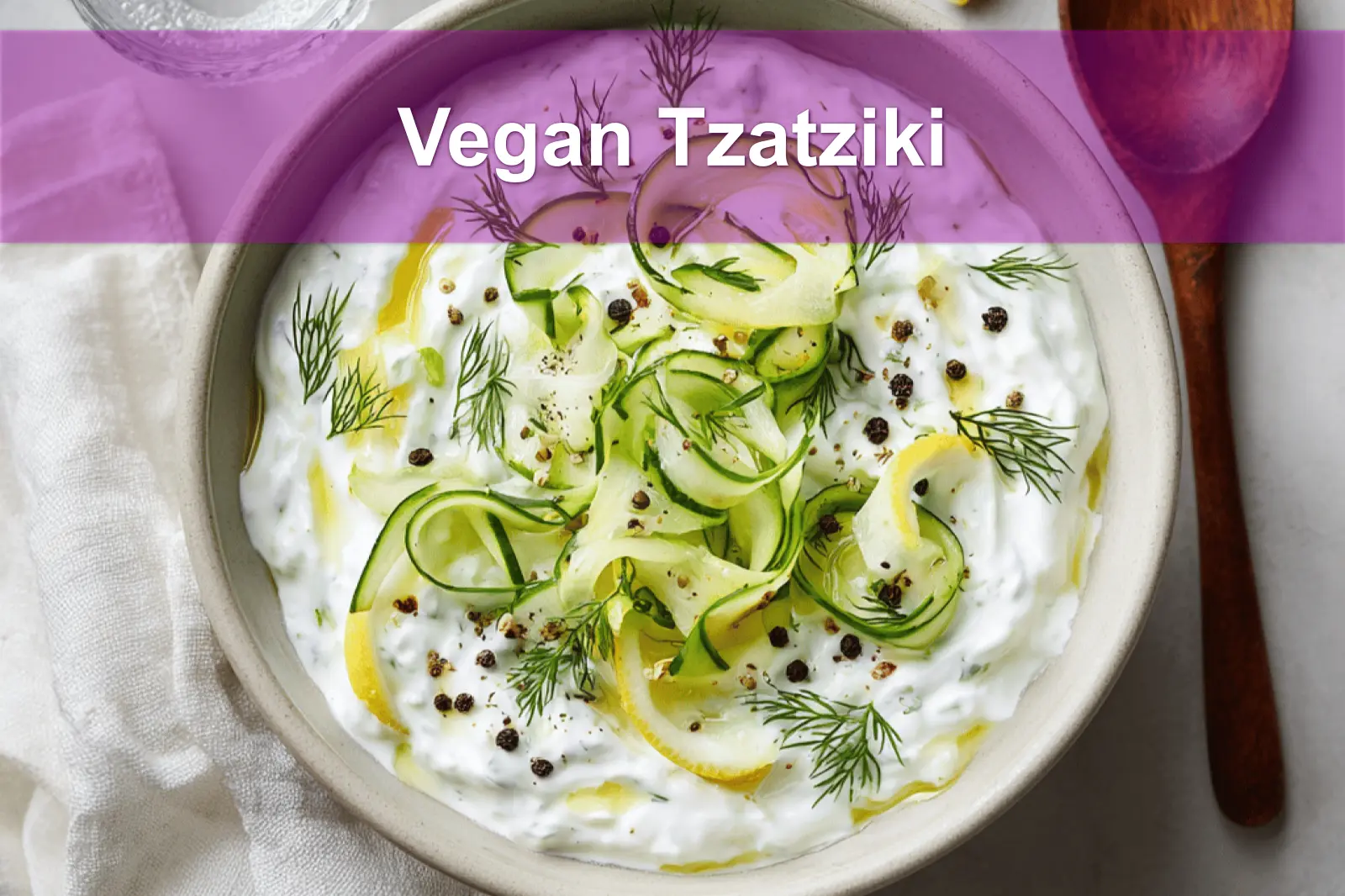 Vegan Tzatziki in ceramic bowl with cucumber dill lemon and olive oil drizzle