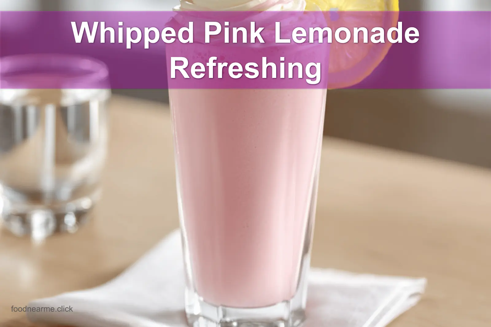 Whipped Pink Lemonade Refreshing Recipe in a clear glass, lightly styled with a raspberry garnish.