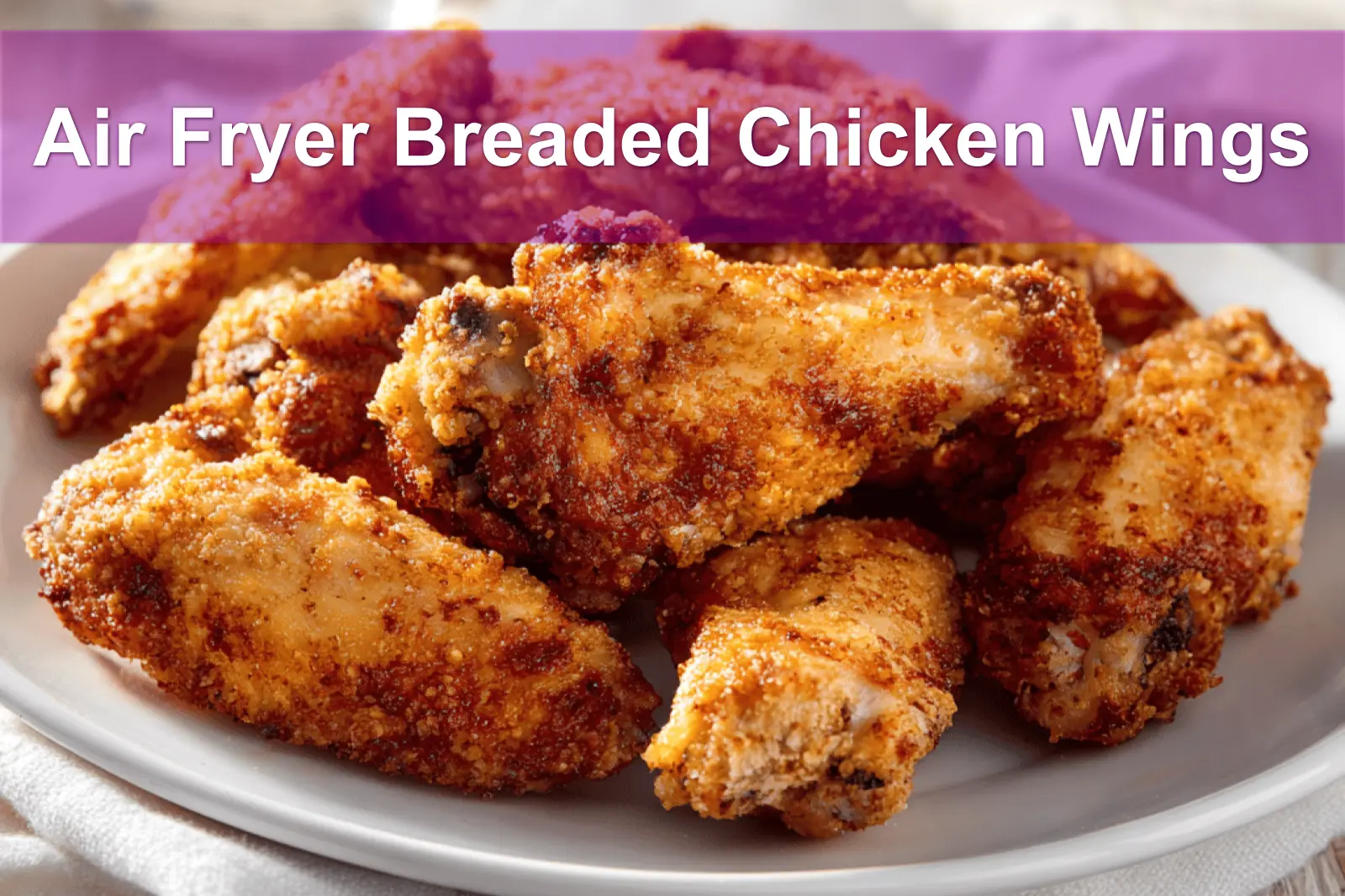 Air Fryer Breaded Chicken Wings plated with golden crust and simple glass of water
