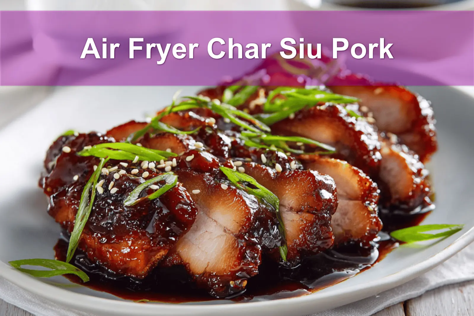 Air Fryer Char Siu Pork sliced glazed on white napkin with clear glass of water