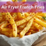 Crispy Air Fryer French Fries on white napkin with clear water glass and warm tones