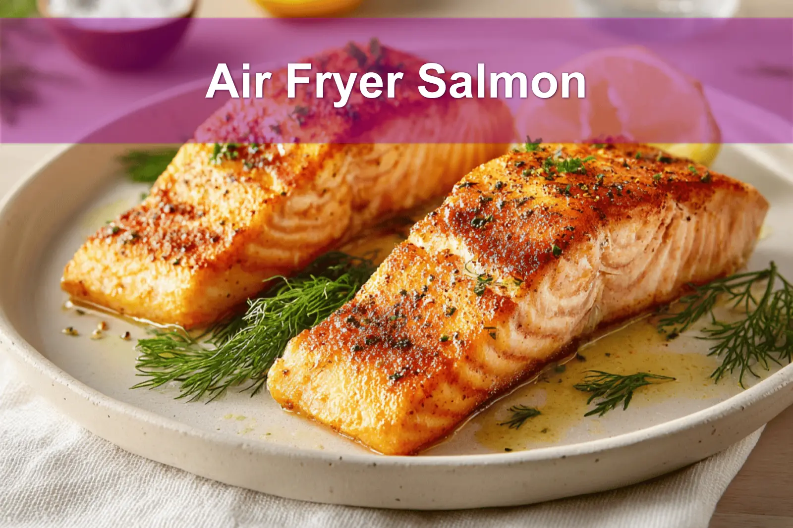 Air Fryer Salmon on ceramic plate with lemon wedges and fresh herbs