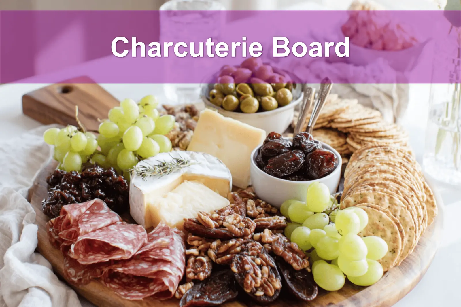 Charcuterie Board with brie prosciutto grapes figs crackers on warm styled table