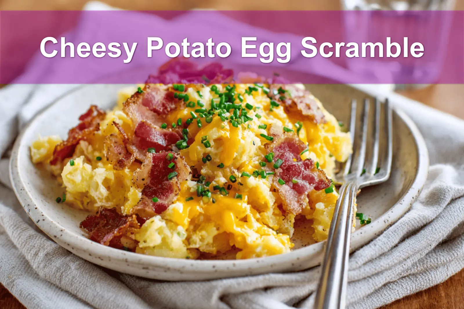 Cheesy Potato Egg Scramble plated with crispy potatoes scrambled eggs cheddar bacon and chives