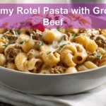 Creamy Rotel Pasta with Ground Beef plated with melted cheese and fresh herbs