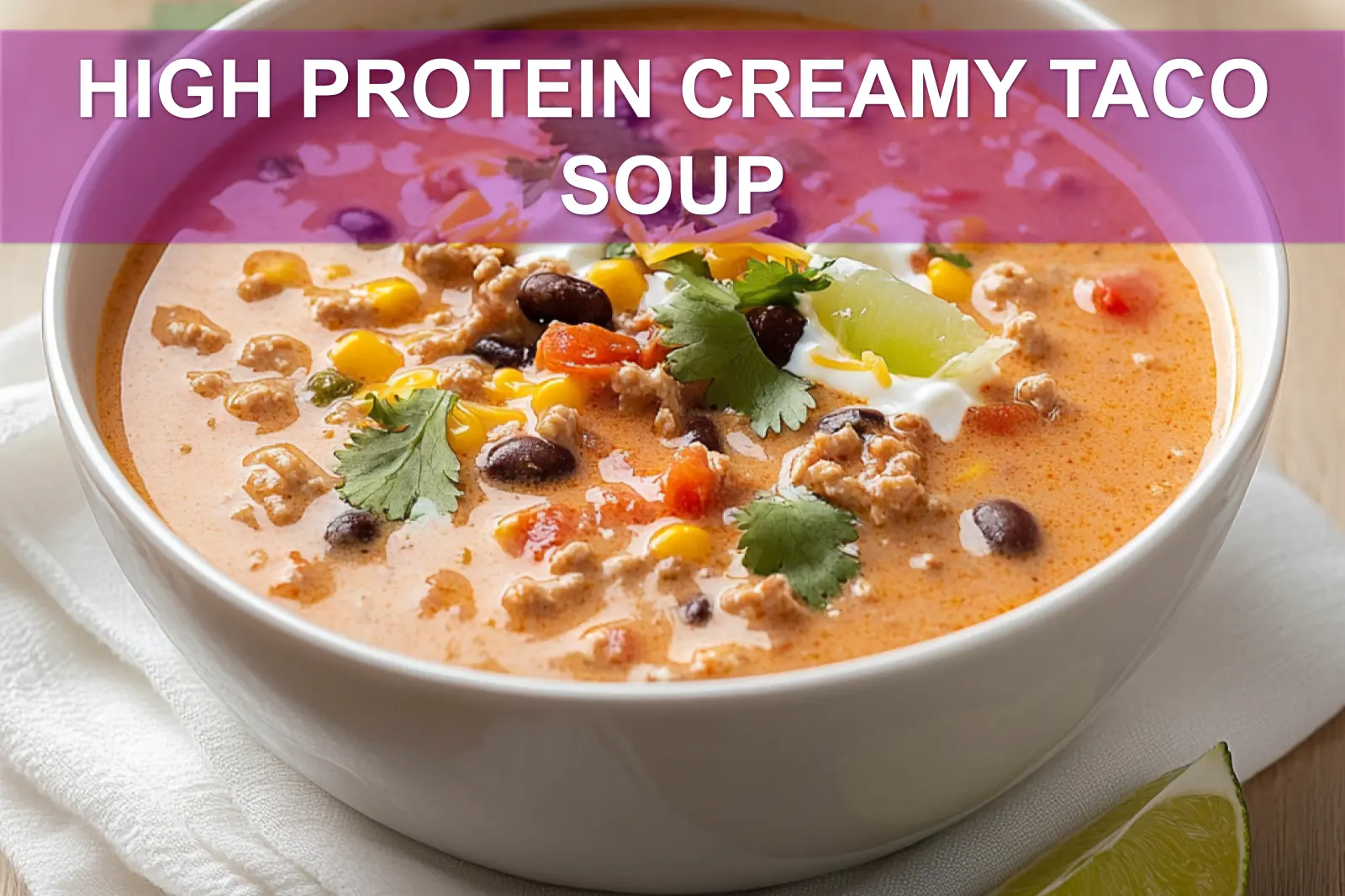 Creamy taco soup topped with sour cream and cilantro, packed with protein