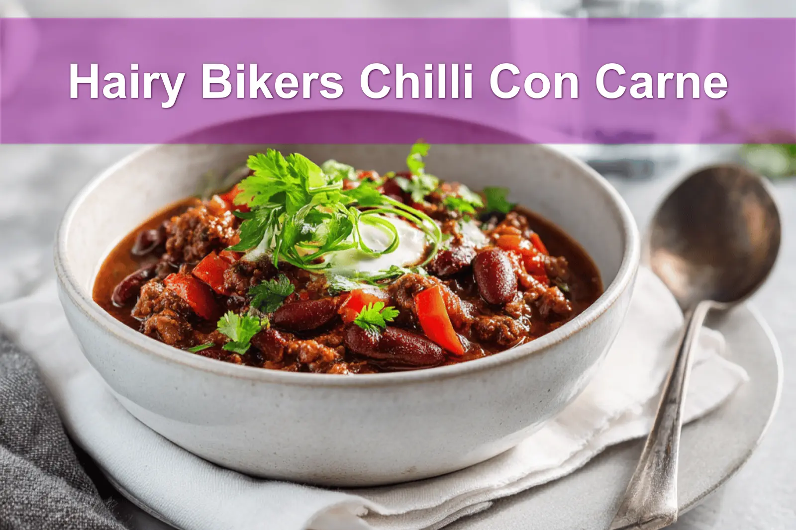 Hairy Bikers Chilli Con Carne hearty bowl on white napkin with glass of water