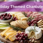 Holiday Themed Charcuterie board with salami prosciutto aged cheddar brie grapes apples and herbs