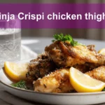 Ninja Crispi chicken thighs crispy golden skin bone-in skin-on chicken pieces on white cloth