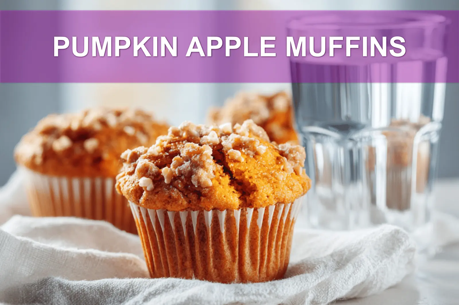 PUMPKIN APPLE MUFFINS hero shot three quarter angle warm tones on white cloth