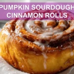 PUMPKIN SOURDOUGH CINNAMON ROLLS warm three quarter hero shot with glass of water