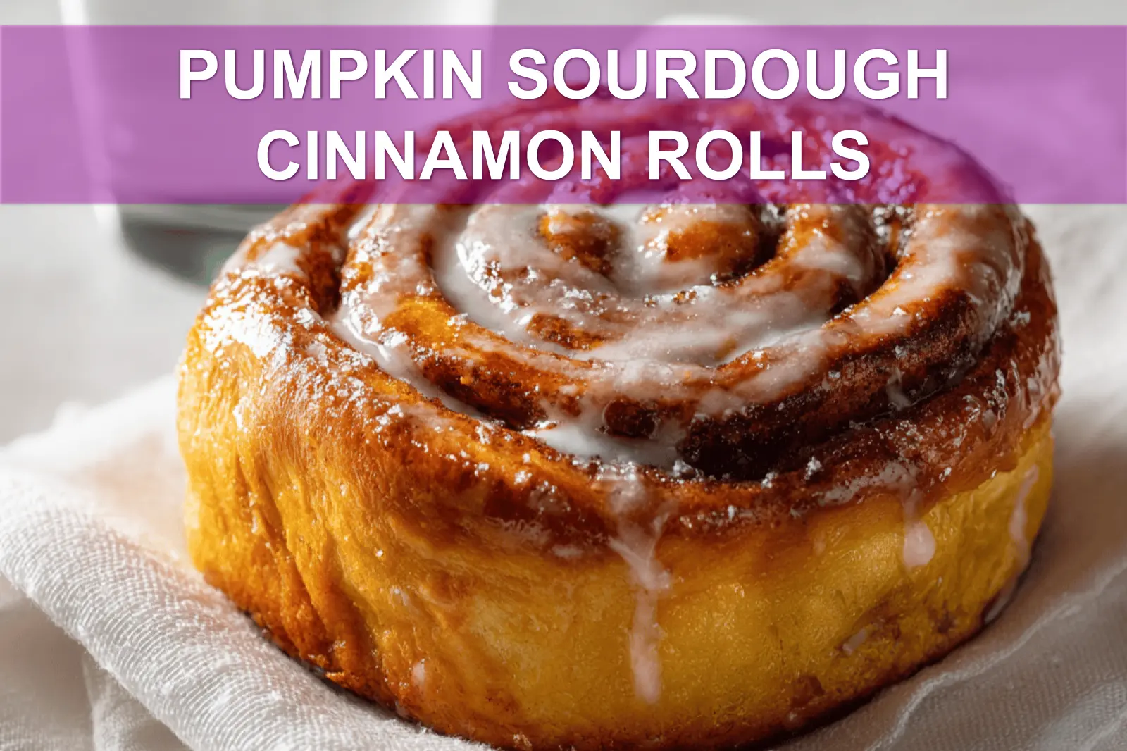 PUMPKIN SOURDOUGH CINNAMON ROLLS warm three quarter hero shot with glass of water