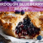 SOURDOUGH BLUEBERRY PIE RECIPE hero image warm natural light slice on white cloth