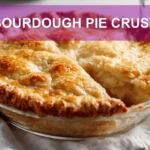 SOURDOUGH PIE CRUST golden flaky crust on white napkin with clear water glass hero image
