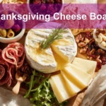 Thanksgiving Cheese Board with brie manchego white cheddar cranberry goat cheese assorted salami