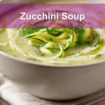 Zucchini Soup garnished with dill in white bowl on cloth beside clear water glass