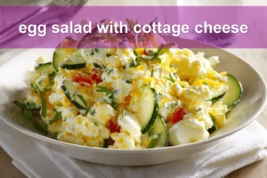 Egg salad with cottage cheese on white napkin, vibrant peppers and herbs, water glass