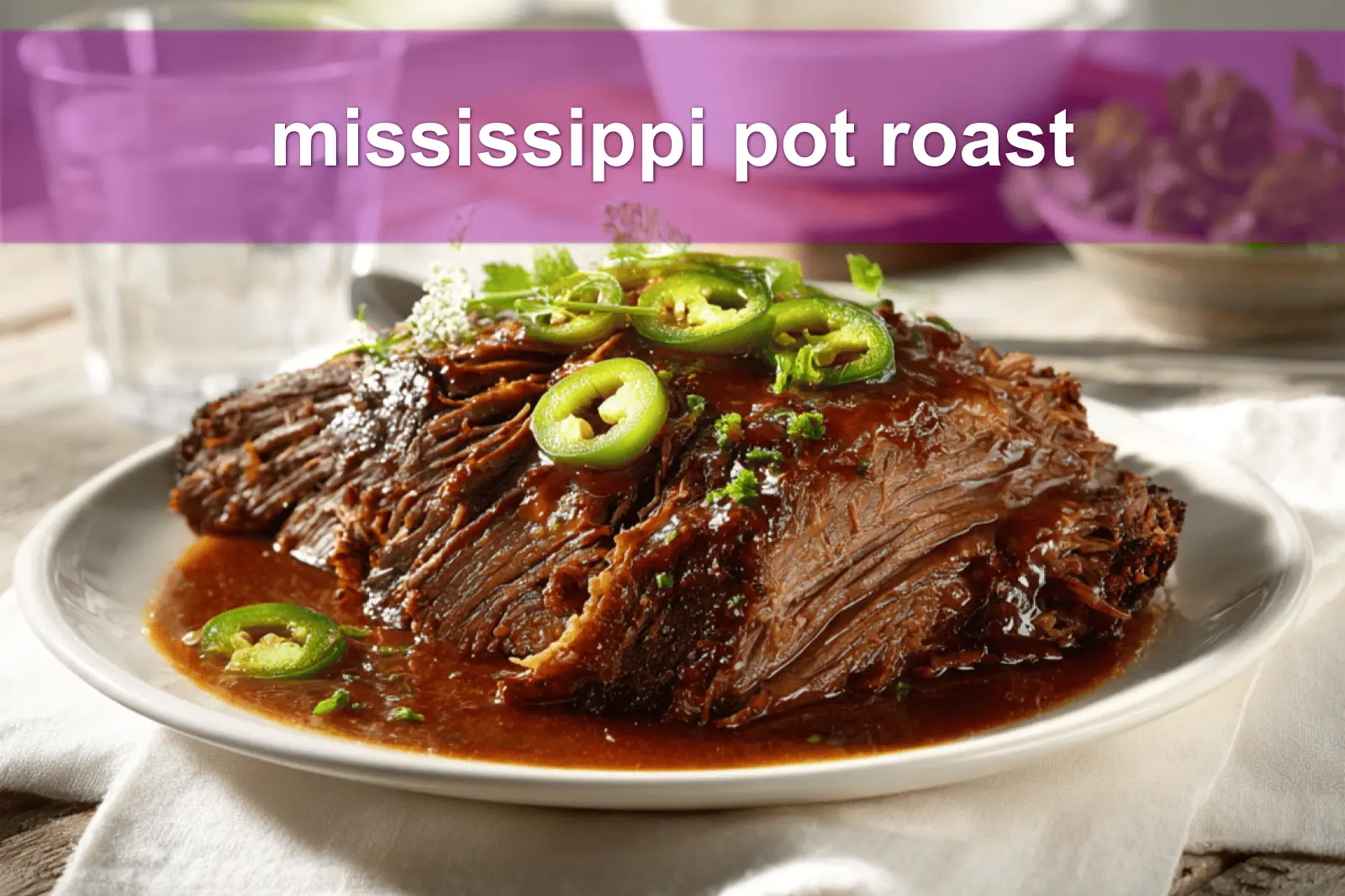 mississippi pot roast on white napkin with buttery glaze and clear glass of water