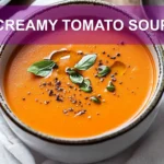 CREAMY TOMATO SOUP in a creamy bowl with basil garnish warm inviting main blog image