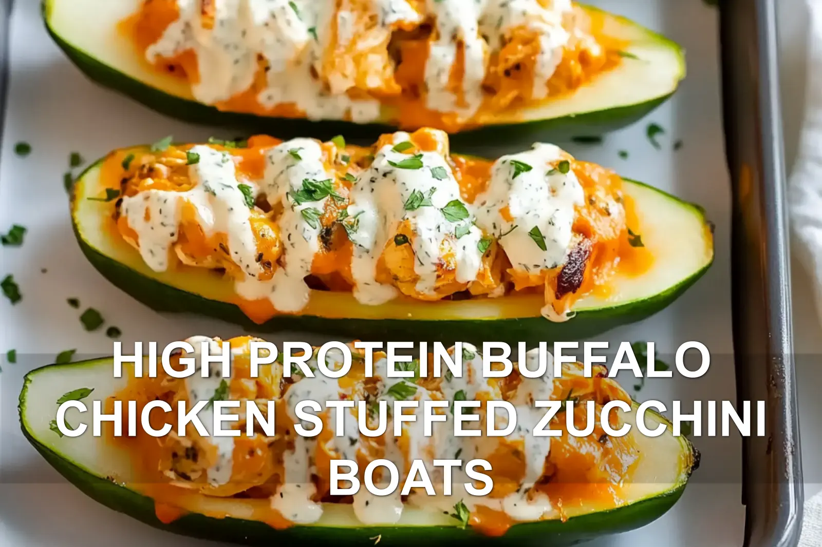 High protein buffalo chicken stuffed zucchini boats topped with melted cheese
