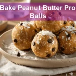 NO BAKE PEANUT BUTTER PROTEIN BALLS on white cloth with clear glass of water, warm styling