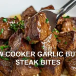 SLOW COOKER GARLIC BUTTER STEAK BITES centered hero view, clean and uncluttered
