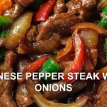 CHINESE PEPPER STEAK WITH ONIONS centered hero view, clean and uncluttered