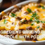 5 INGREDIENT GROUND BEEF CASSEROLE WITH POTATOES in white baking dish with golden cheese topping