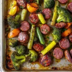 SHEET PAN SAUSAGE AND VEGETABLES centered hero view, clean and uncluttered